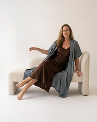 Natalie Noor wearing the moonstone blue Mirage robe with intricate metallic black and gold embroidery. A Luxury Sahara Resort Wear collection.