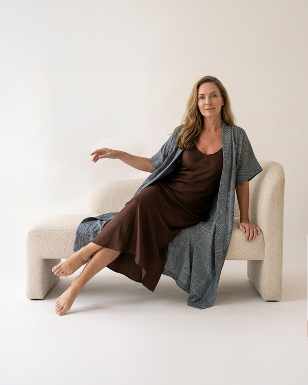 Natalie Noor wearing the moonstone blue Mirage robe with intricate metallic black and gold embroidery. A Luxury Sahara Resort Wear collection.