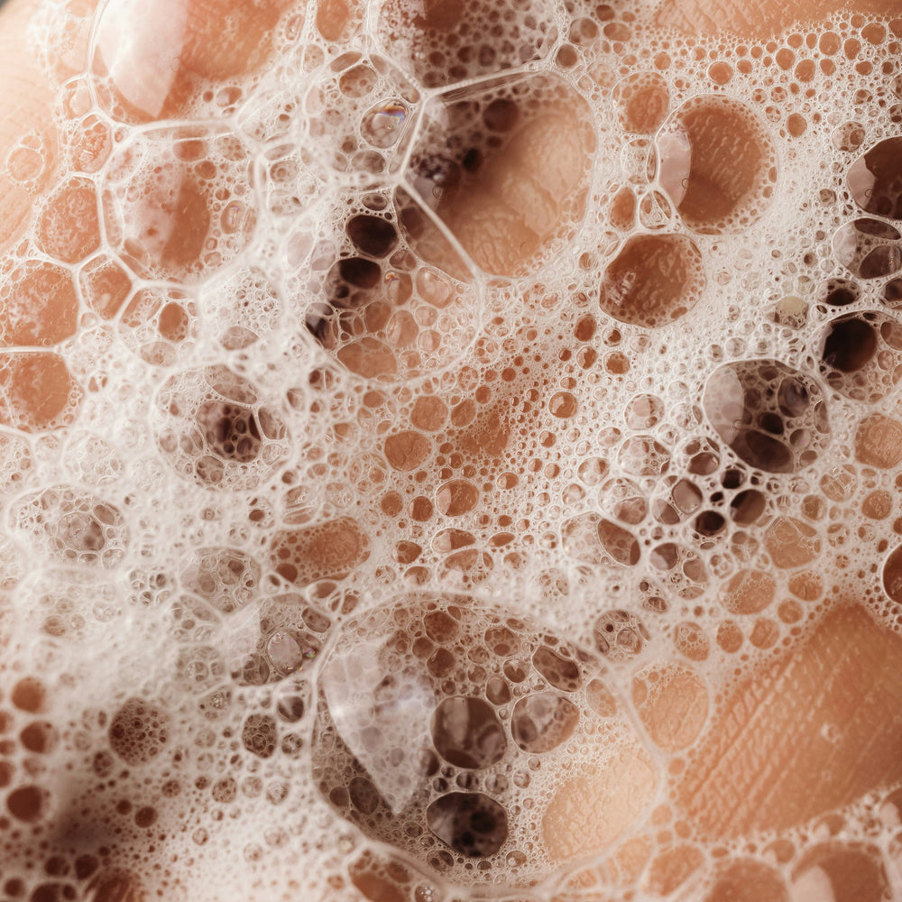 Close-up of a hand with soap bubbles on skin