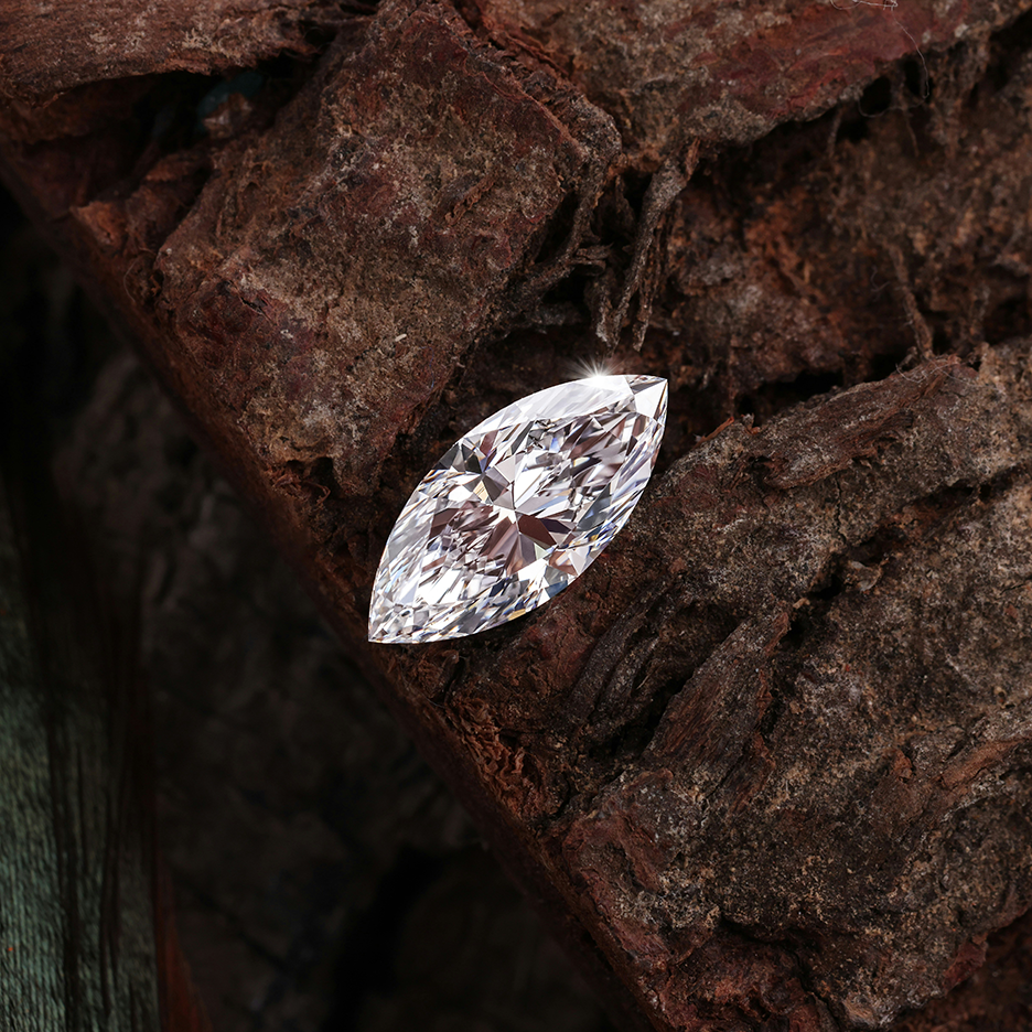 Clear Gemstone on a textured brown surface. Jewelry Lit by Desire - Natalie Noor