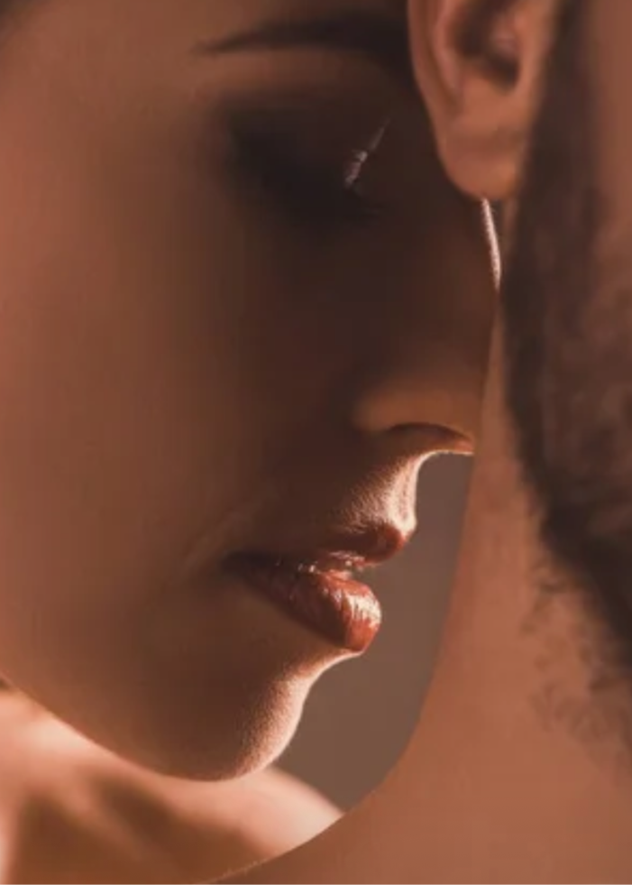 Close-up of a couple embracing with a warm, intimate atmosphere.