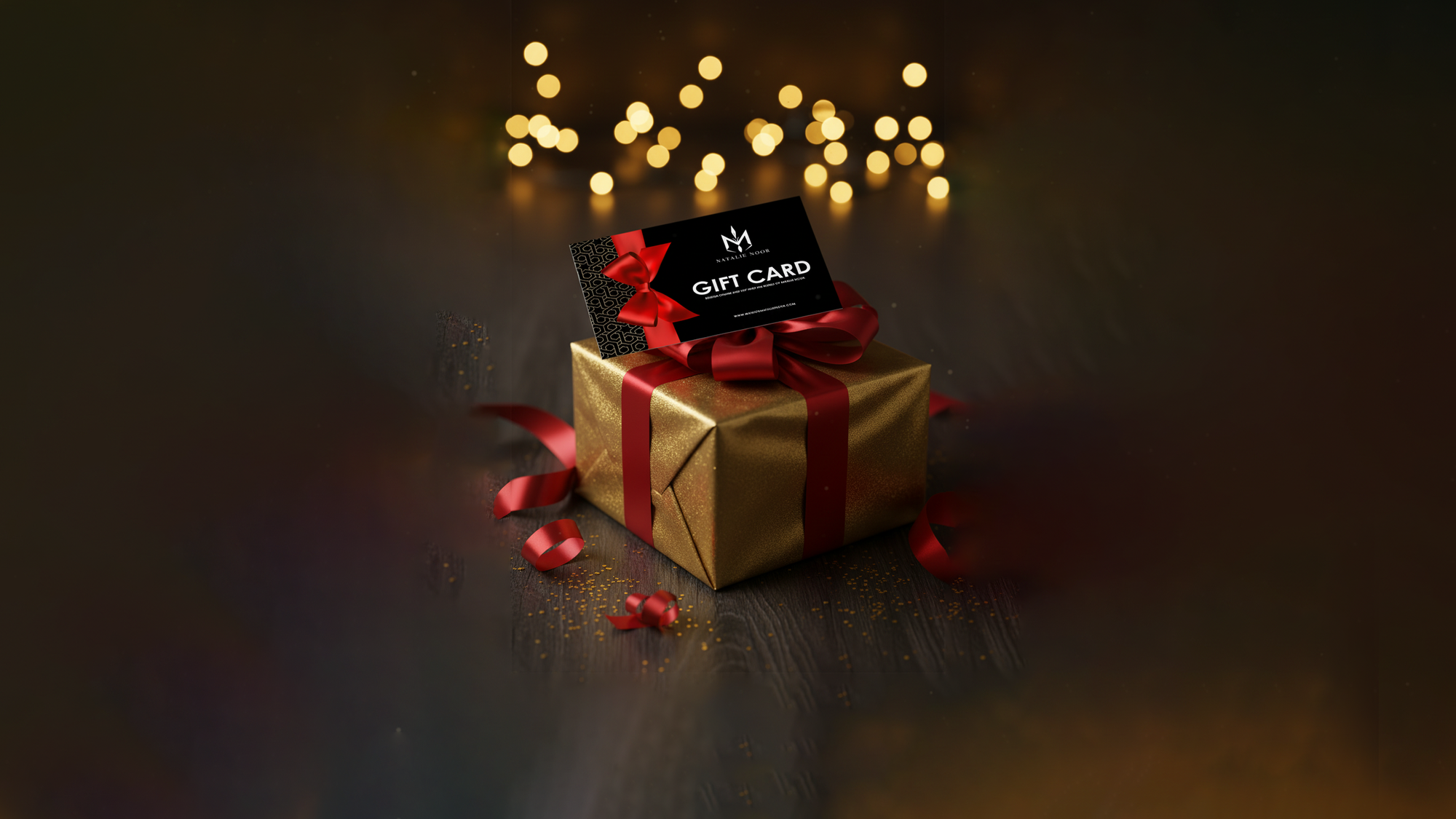 Gold gift box with red ribbon and a gift card on a dark background with blurred lights. Gift Card Natalie Noor