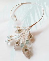 Delicate sterling silver torc necklace with blue obsidian gemstones on a light background. Maison Natalie Noor, jewelry lit by desire.